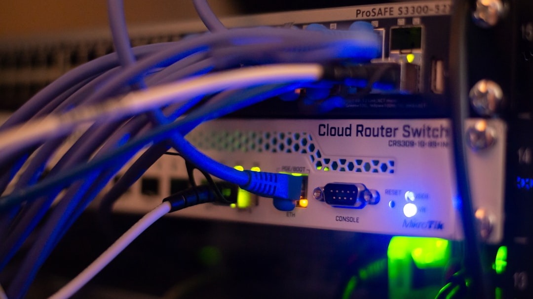 Network equipment with many colorful cables plugged in.